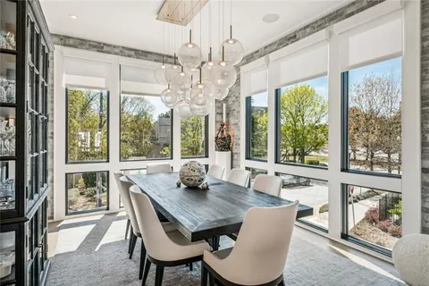 a view of a dining room with furniture large windows and wooden floor