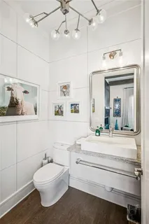 a bathroom with a sink a mirror and a toilet