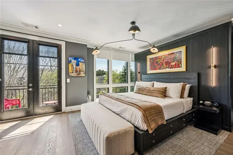 a bedroom with a large bed and a chandelier