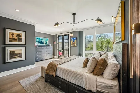 a bedroom with bed and a large window