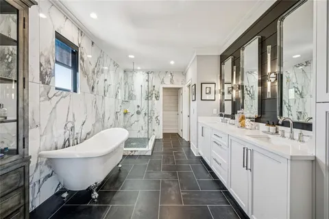 a bathroom with double vanity sinks and a mirror