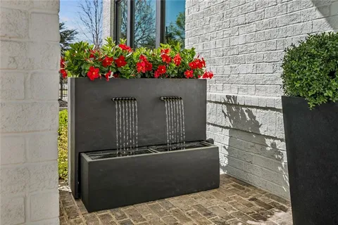 a front view of a house with a bunch of flowers