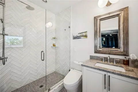 an outdoor living with seating space and stainless steel appliances