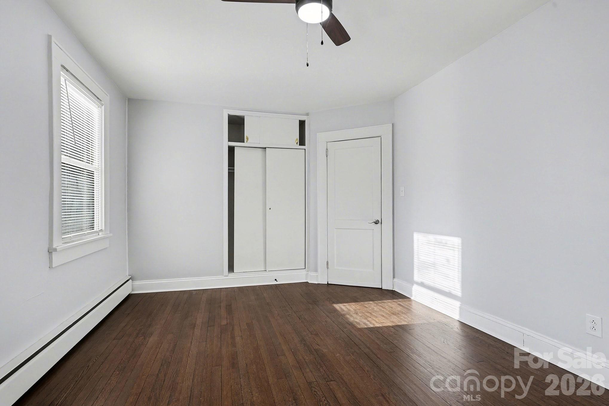 225 Valleyview Place Salisbury, NC 28144 - Photo 18 of 36 an empty room with wooden floor cabinet and windows