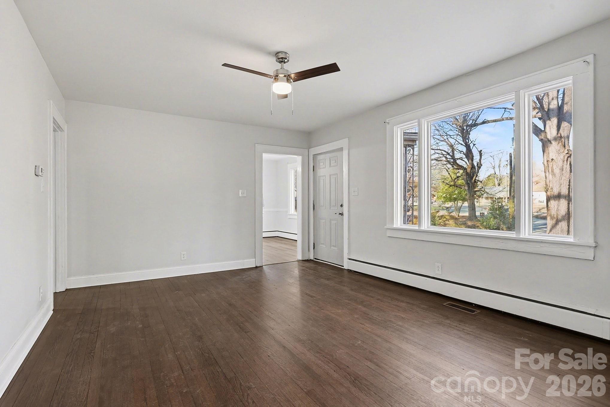 225 Valleyview Place Salisbury, NC 28144 - Photo 6 of 36 a view of an empty room with a window and wooden floor