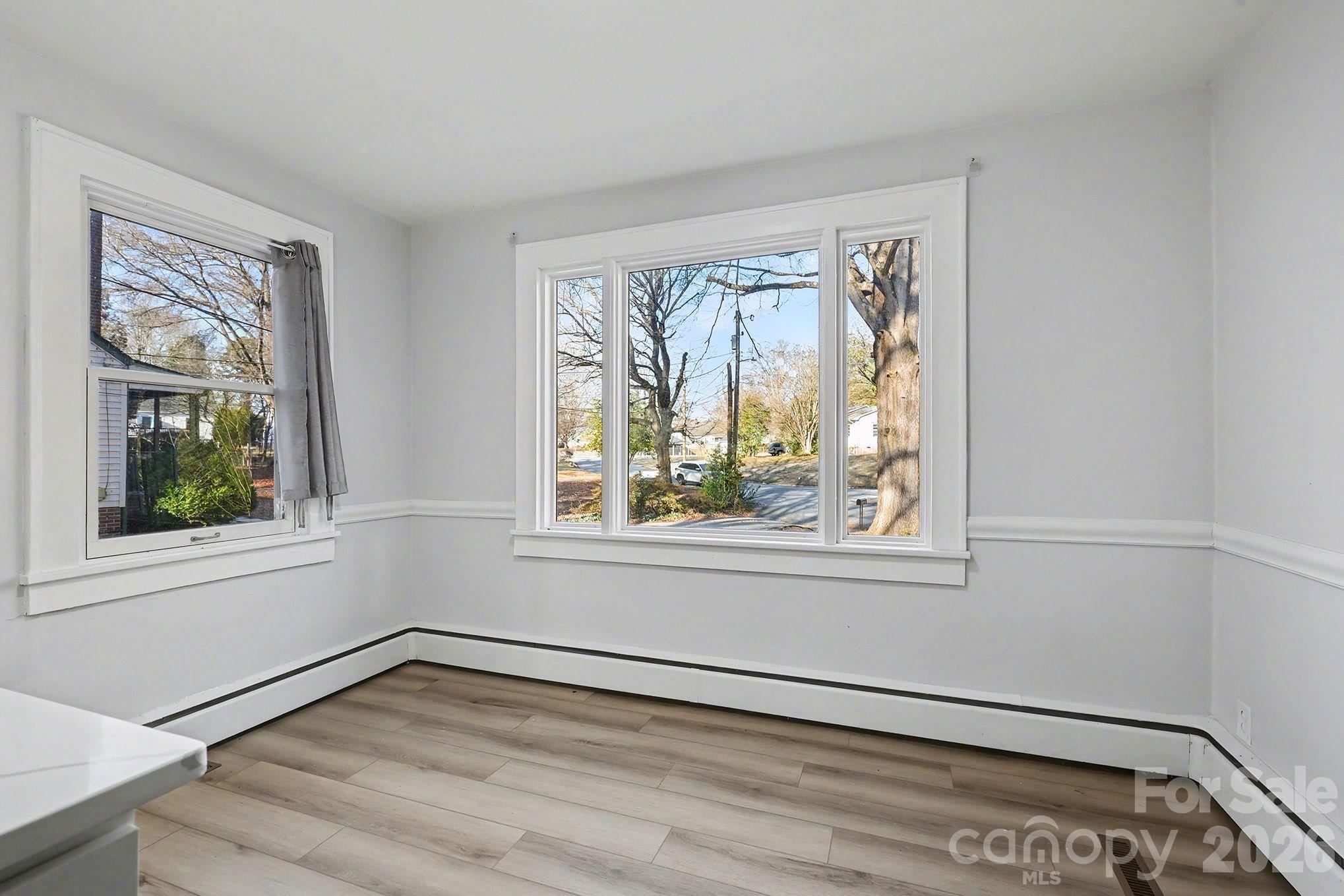 225 Valleyview Place Salisbury, NC 28144 - Photo 9 of 36 a view of an empty room with a window and wooden floor
