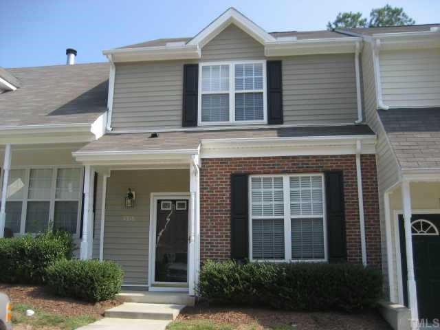 front view of a brick house with a large window