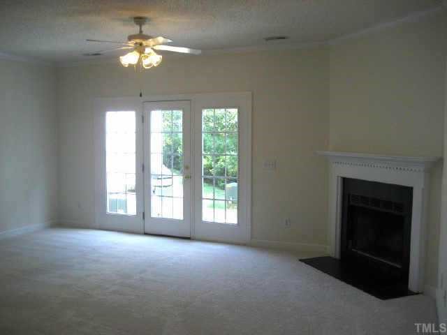 7318 Bonnie Ridge Court Raleigh, NC 27615 - Photo 6 of 9 a view of empty room with a fireplace