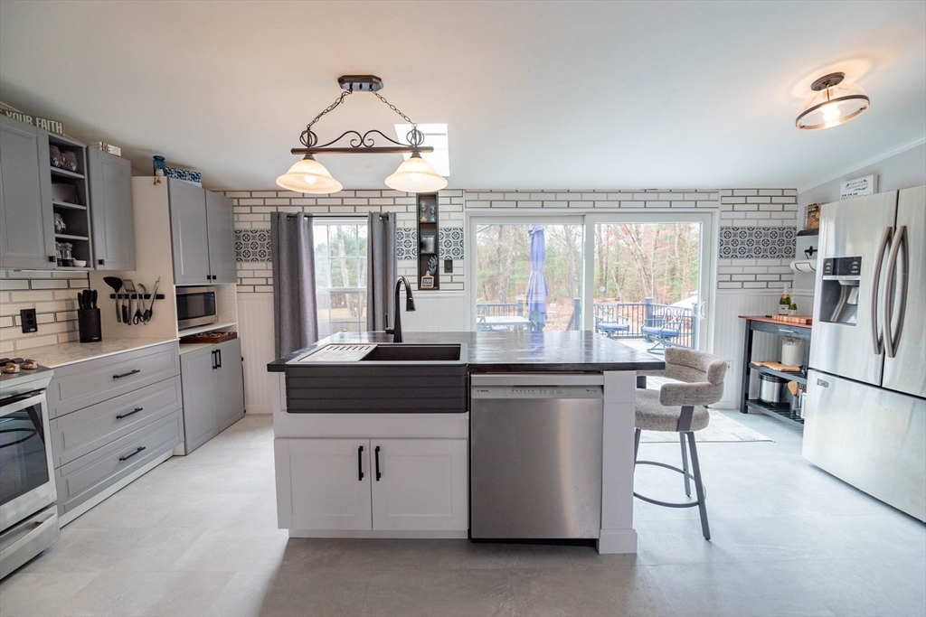 4 Norbell Street Three Rivers, MA 01080 - Photo 8 of 42 a kitchen with stainless steel appliances granite countertop a stove oven and a refrigerator