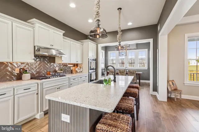 a kitchen with a sink and a stove top oven