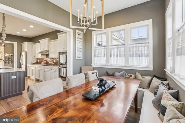 a spacious bedroom with a bed a dresser next to a window