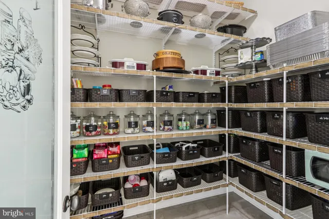 a spacious bedroom with a bed and a chandelier