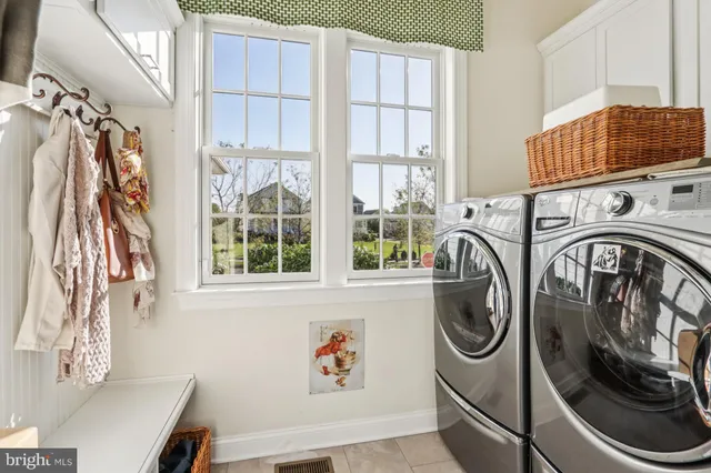 a living room with furniture a fireplace and a large window