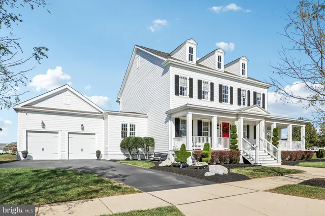 a front view of a house with a garden and plants
