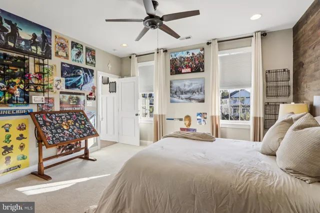 a living room with stainless steel appliances furniture a rug and a kitchen view