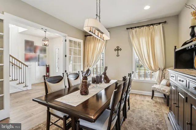 a living room with fireplace furniture and a large window