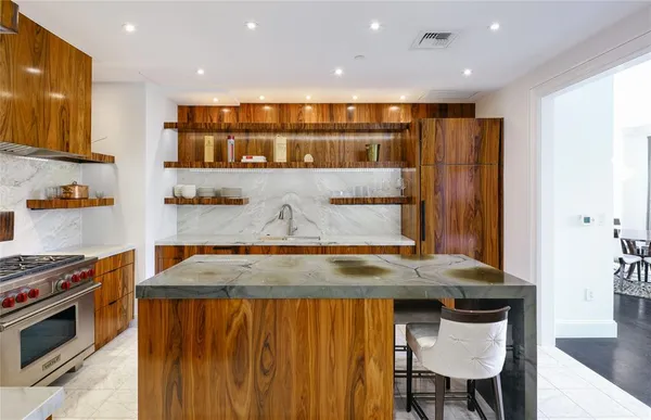 a kitchen with stainless steel appliances wooden cabinets and a stove top oven