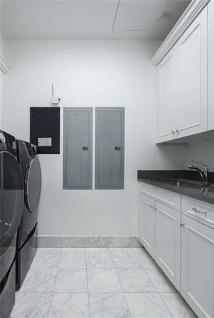 a kitchen with granite countertop a sink dishwasher a stove and a microwave oven