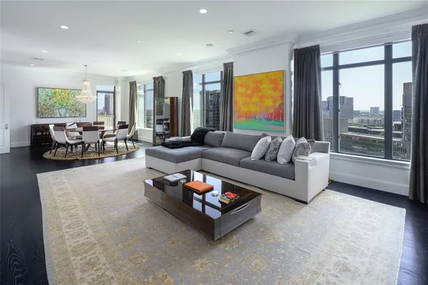 a living room with furniture and large windows