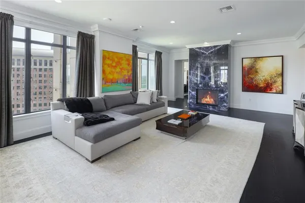 a living room with furniture flat screen tv and a large window