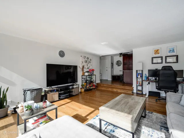 a living room with stainless steel appliances kitchen island granite countertop furniture and a kitchen view