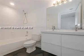 a bathroom with a sink a toilet and a bathtub