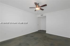 1688 West Avenue, Unit PH07 Miami Beach, FL 33139 - Photo 20 of 26 an empty room with a chandelier fan and a ceiling fan