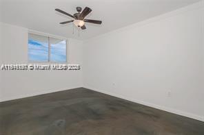 1688 West Avenue, Unit PH07 Miami Beach, FL 33139 - Photo 21 of 26 an empty room with a ceiling fan and a window