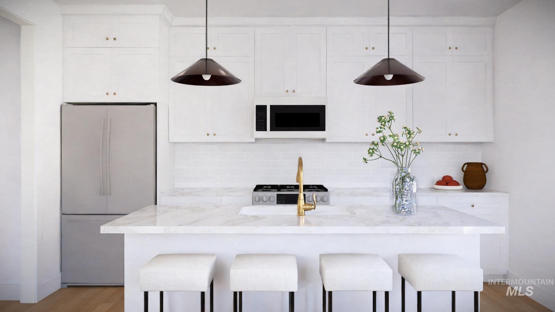 Tbd Tbd Primrose Court, Unit 5 Moscow, ID 83843 - Photo 4 of 20 Kitchen featuring white appliances, white cabinetry, light wood-style floors, and a breakfast bar area