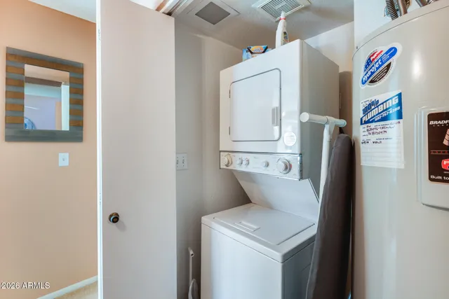 a living room with furniture and a painting on the wall