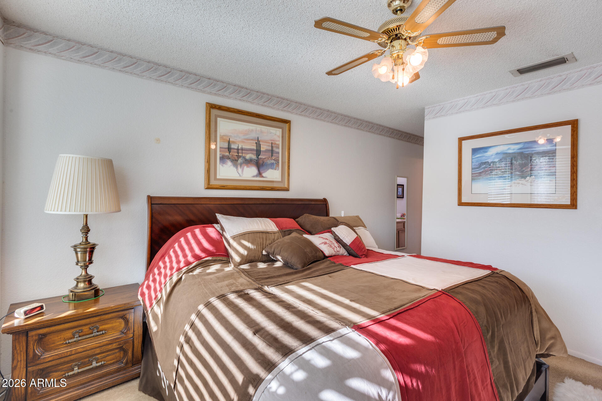 14300 West Bell Road, Unit 482 Surprise, AZ 85374 - Photo 23 of 53 a bedroom with a bed and a lamp on dresser