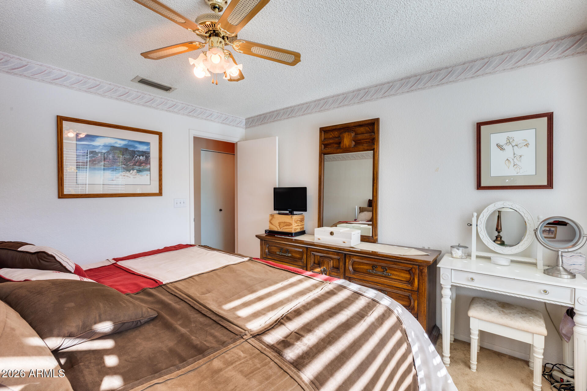 14300 West Bell Road, Unit 482 Surprise, AZ 85374 - Photo 24 of 53 a bedroom with a bed and a table with a dresser
