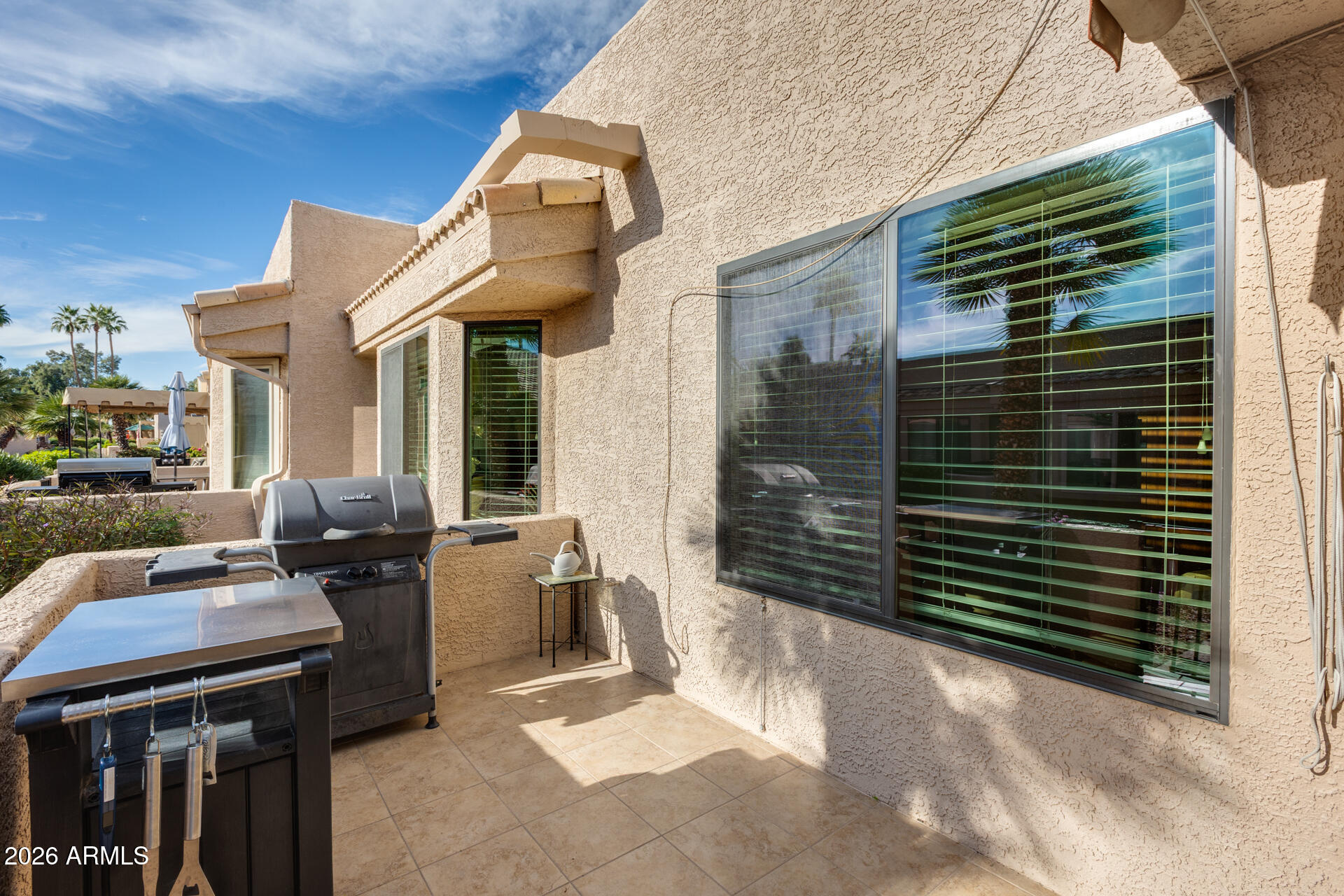 14300 West Bell Road, Unit 482 Surprise, AZ 85374 - Photo 30 of 53 a view of a patio with chairs and a barbeque