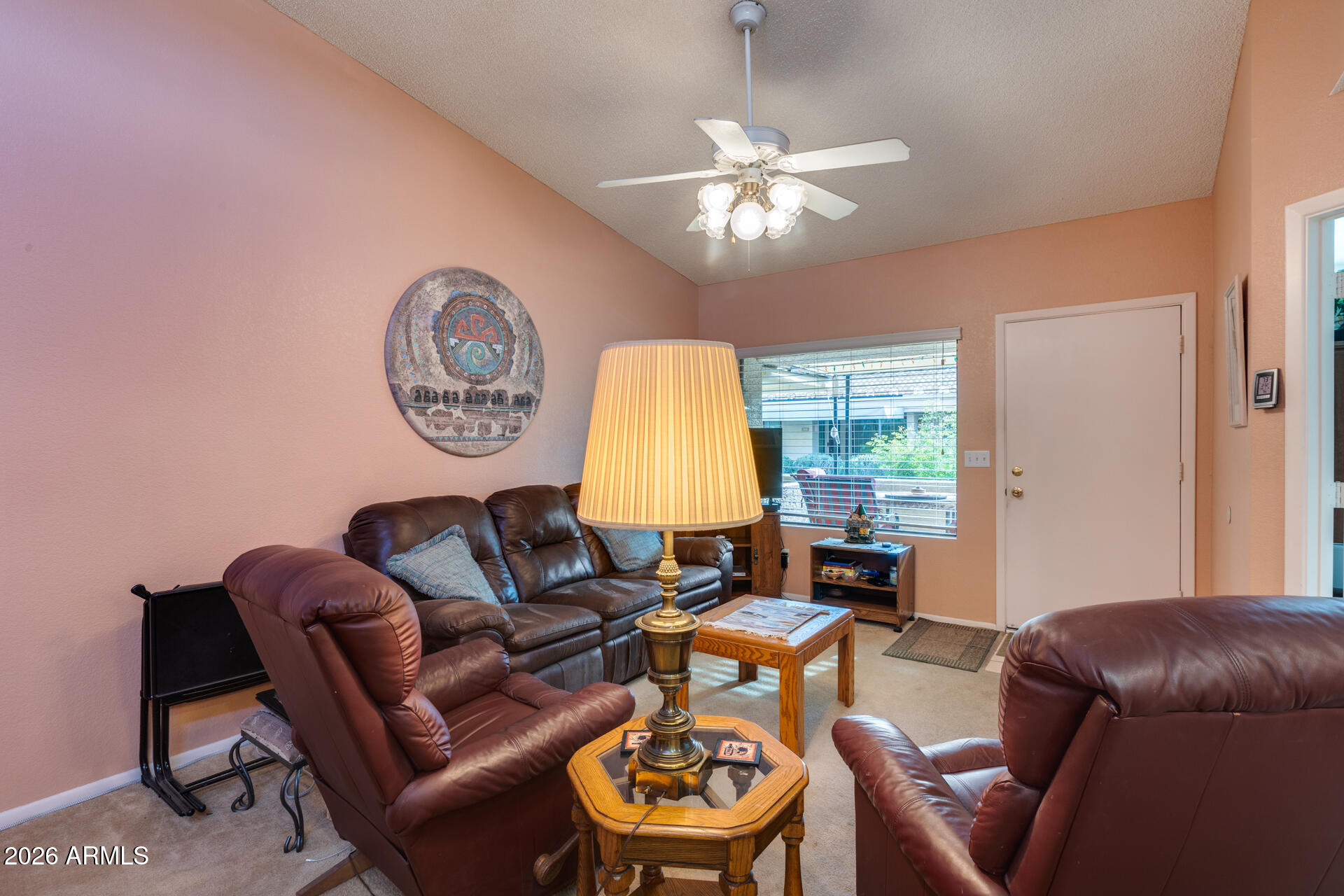 14300 West Bell Road, Unit 482 Surprise, AZ 85374 - Photo 4 of 53 a living room with furniture a window and a chandelier
