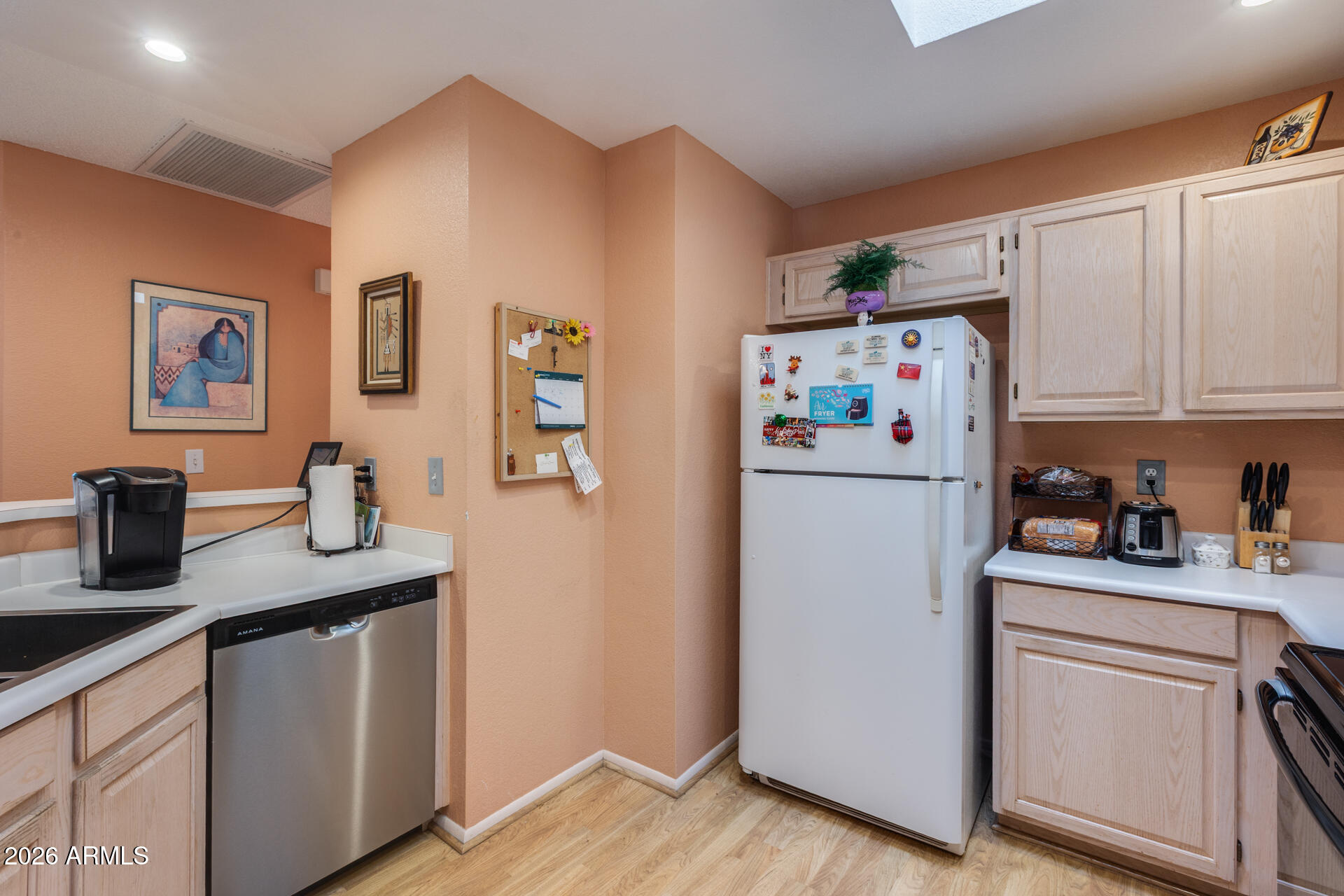 14300 West Bell Road, Unit 482 Surprise, AZ 85374 - Photo 10 of 53 a white refrigerator freezer sitting in a kitchen