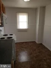 a view of a kitchen with wooden floor and a window
