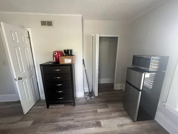 a view of a kitchen with refrigerator and cabinet