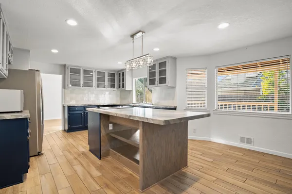 a kitchen with a stove a refrigerator and a sink
