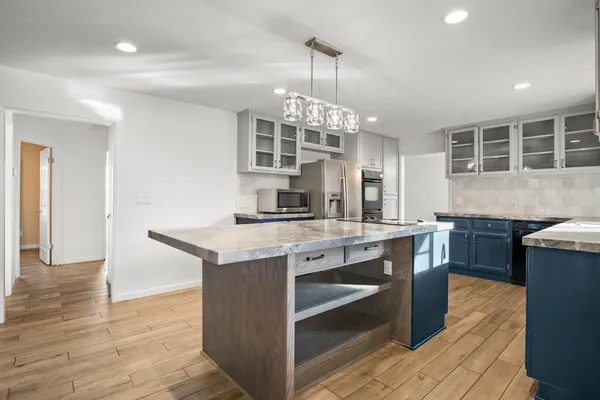 a view of an empty room with a window and fireplace