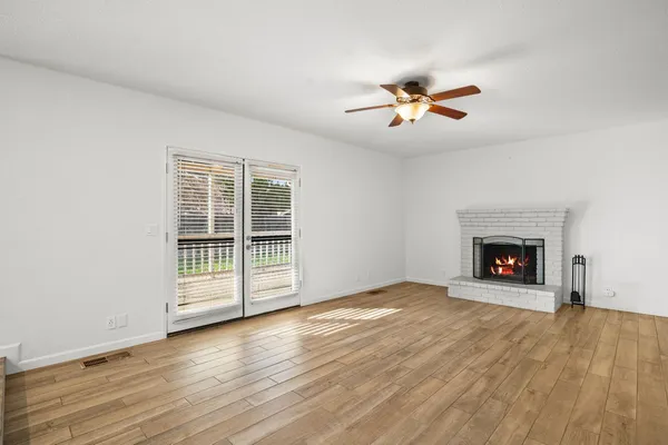a view of a room with a window and wooden floor