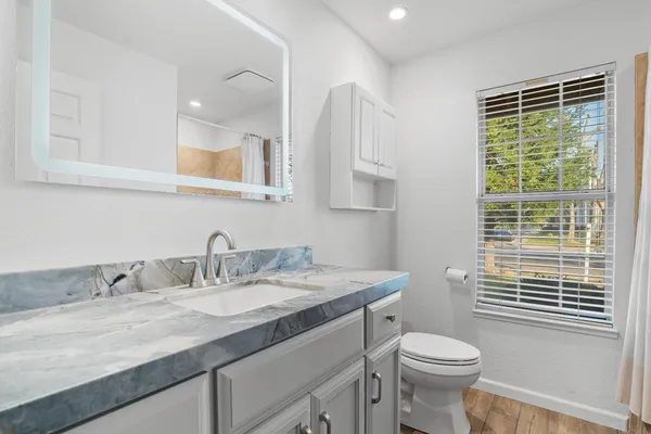 an empty room with fan and windows