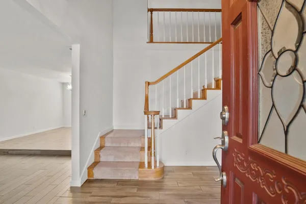 a view of entryway and hall with wooden floor