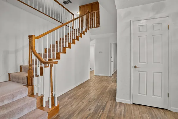 a view of entryway dining room and hall with wooden floor