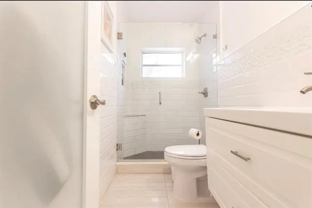 a bathroom with a toilet and a shower