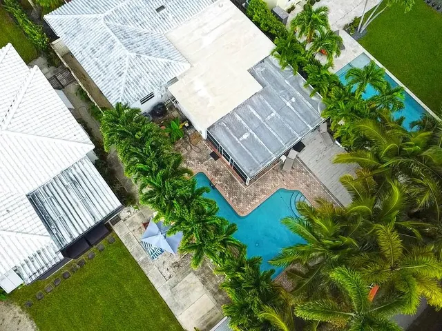 an aerial view of a house with a yard
