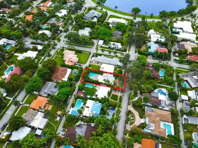 an aerial view of residential houses with outdoor space and street view