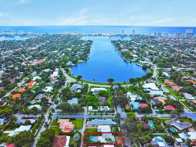 an aerial view of residential houses with outdoor space and swimming pool