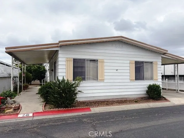 a view of house with outdoor space and parking