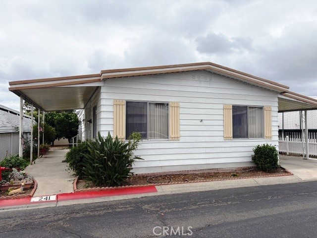 a view of house with outdoor space and parking