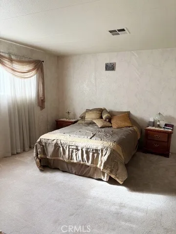 a bedroom with a bed and a cabinets